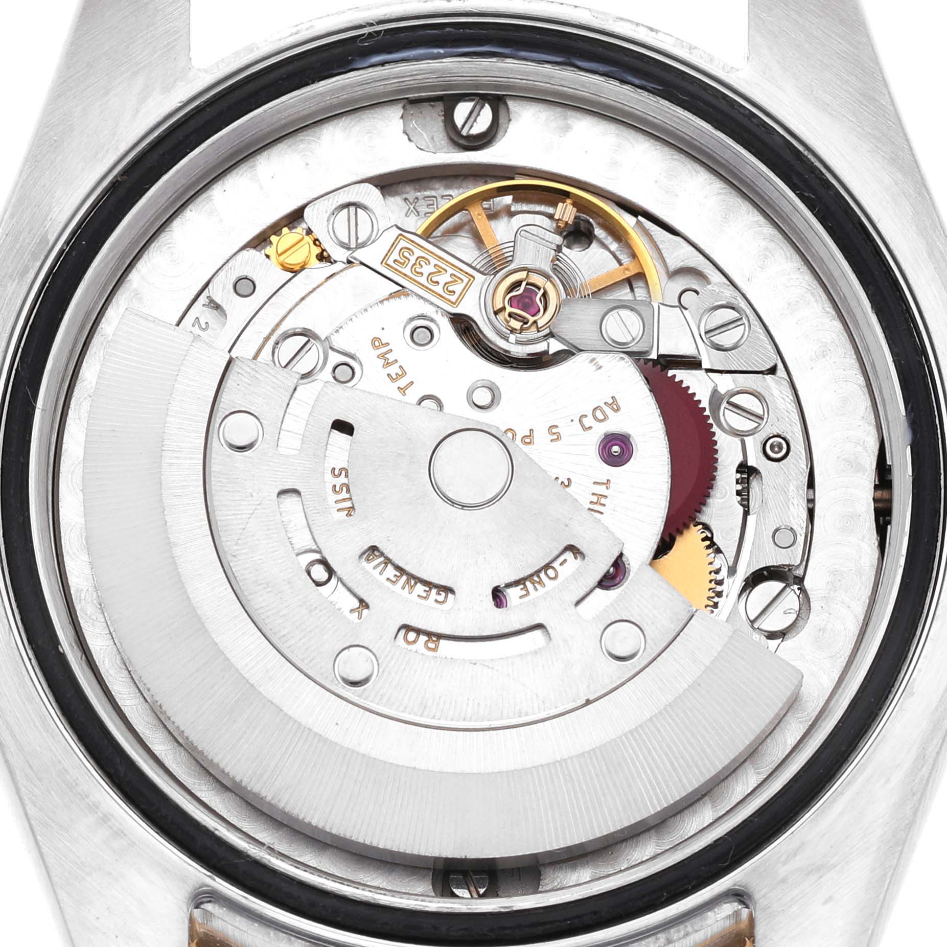 This image shows the movement of a Rolex Mid-Size 178383 Women's Steel and Gold (two tone) Silver Dial watch from a rear angle, highlighting gears and the rotor.