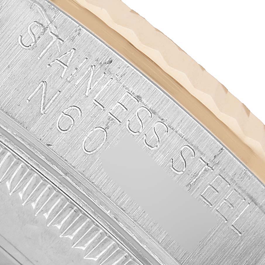 The image shows a close-up of the side of a Rolex Mid-Size 68273 Women's Steel and Gold (two tone) White Dial watch, focusing on the stainless steel bezel.