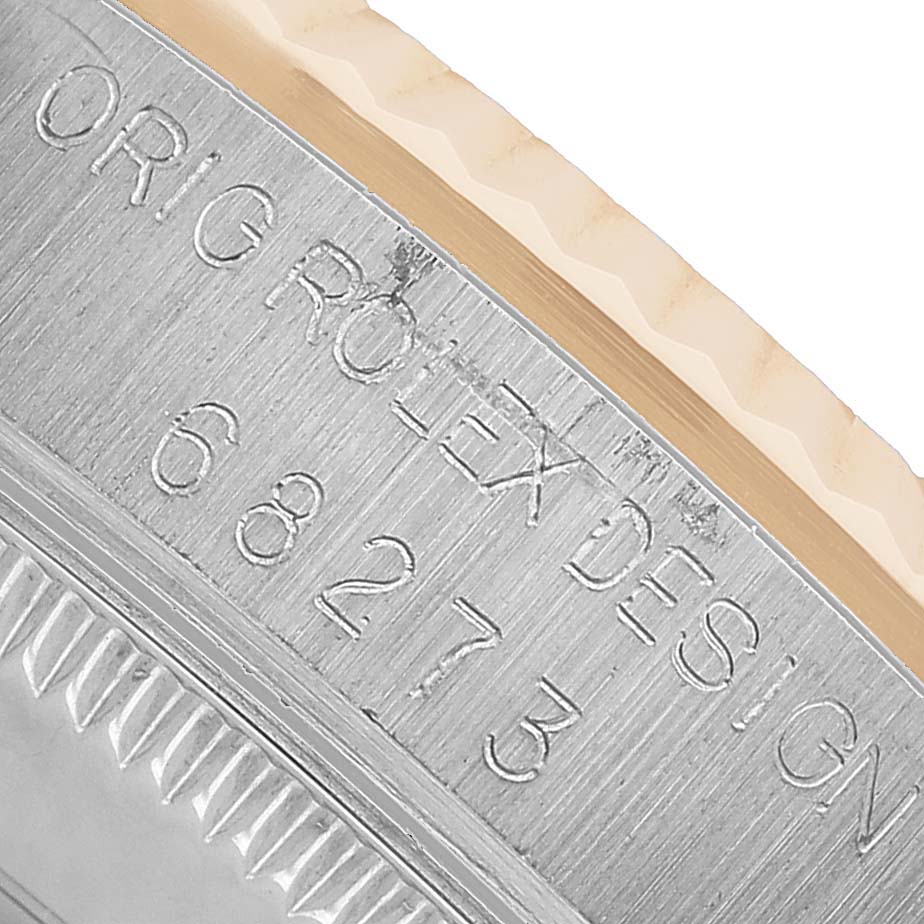 The image shows the side of a Rolex Mid-Size 68273 Women's Steel and Gold (two tone) White Dial watch case with engraved design numbers.