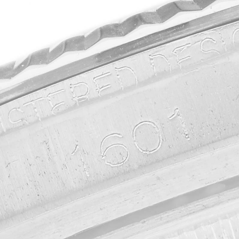 The image shows a close-up of the Rolex Datejust 1601 Men
s Stainless Steel Silver Dial 1601 Men
s Stainless Steel Silver Dial model
s engraved inner bezel with some inscriptions visible.