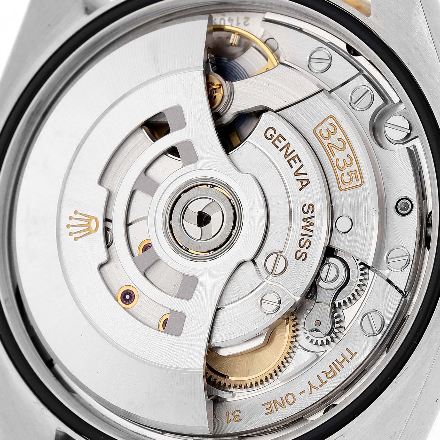 The image shows the Rolex Datejust 126283 Women's Steel and Gold (two tone) Green Dial's movement, featuring the rotor, gears, and intricate engravings at a close-up angle.