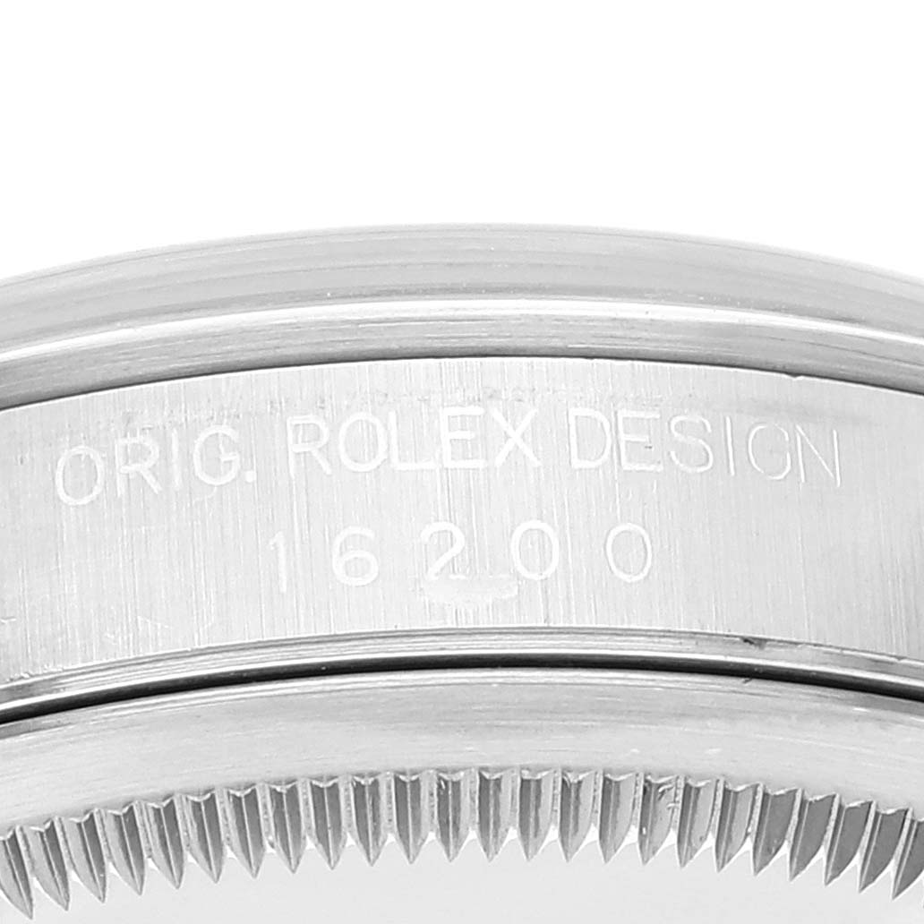 The image shows a close-up of the side of a Rolex Datejust 16200 Men's Stainless Steel Black Dial 16200 Men's Stainless Steel Black Dial, highlighting its model number "16200" and the inscription "ORIG. ROLEX DESIGN."