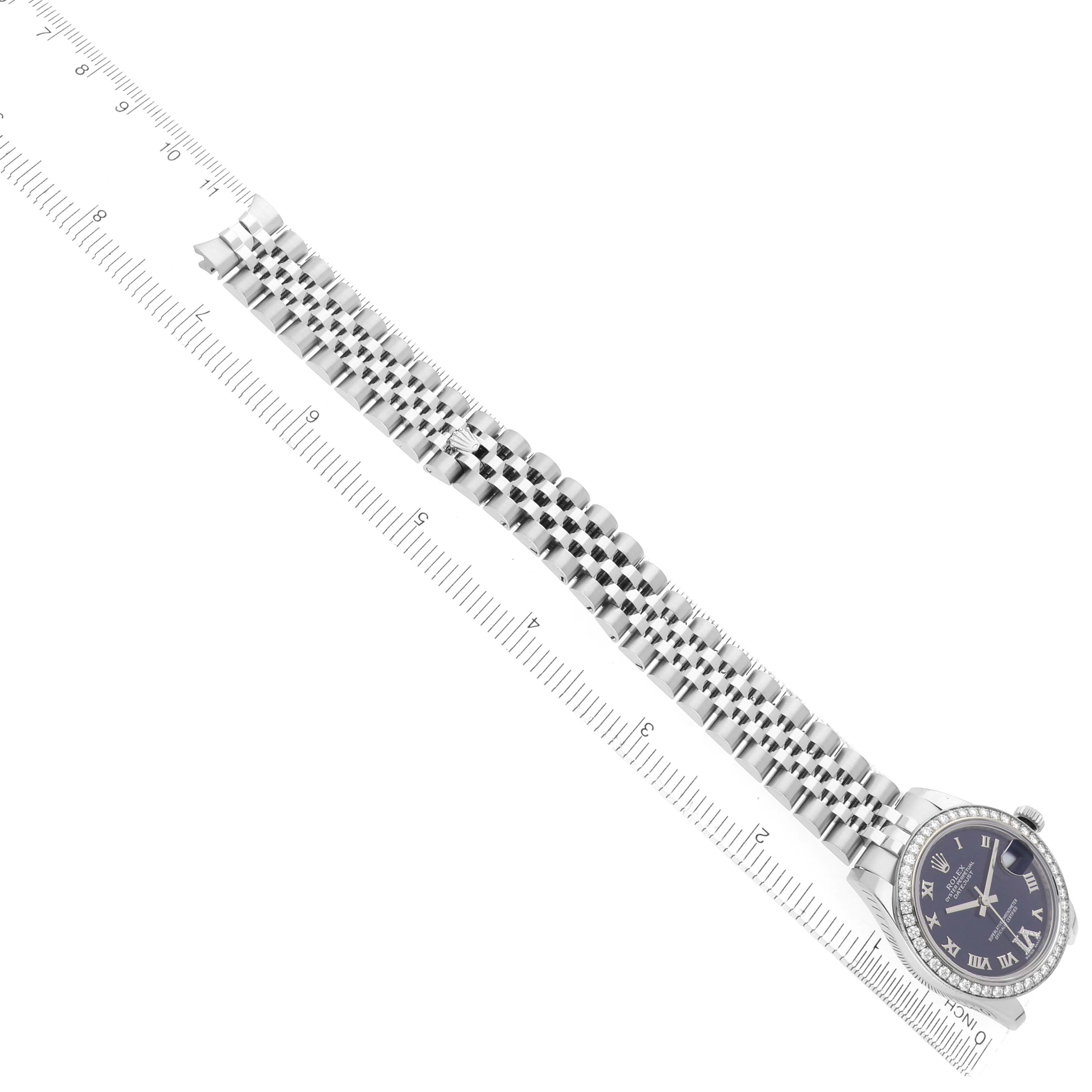 The Rolex Mid-Size 178384 Women
s Stainless Steel Purple Dial 178384 Women
s Stainless Steel Purple Dial model watch is shown from a top-down angle, featuring the face, bracelet, and part of a ruler for scale.
