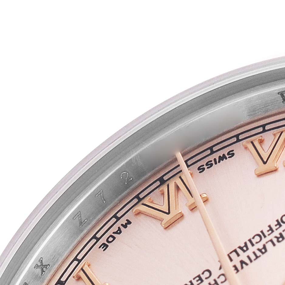 The partial dial and edge of the bezel of the Mid-Size Rolex watch are shown at an angle.