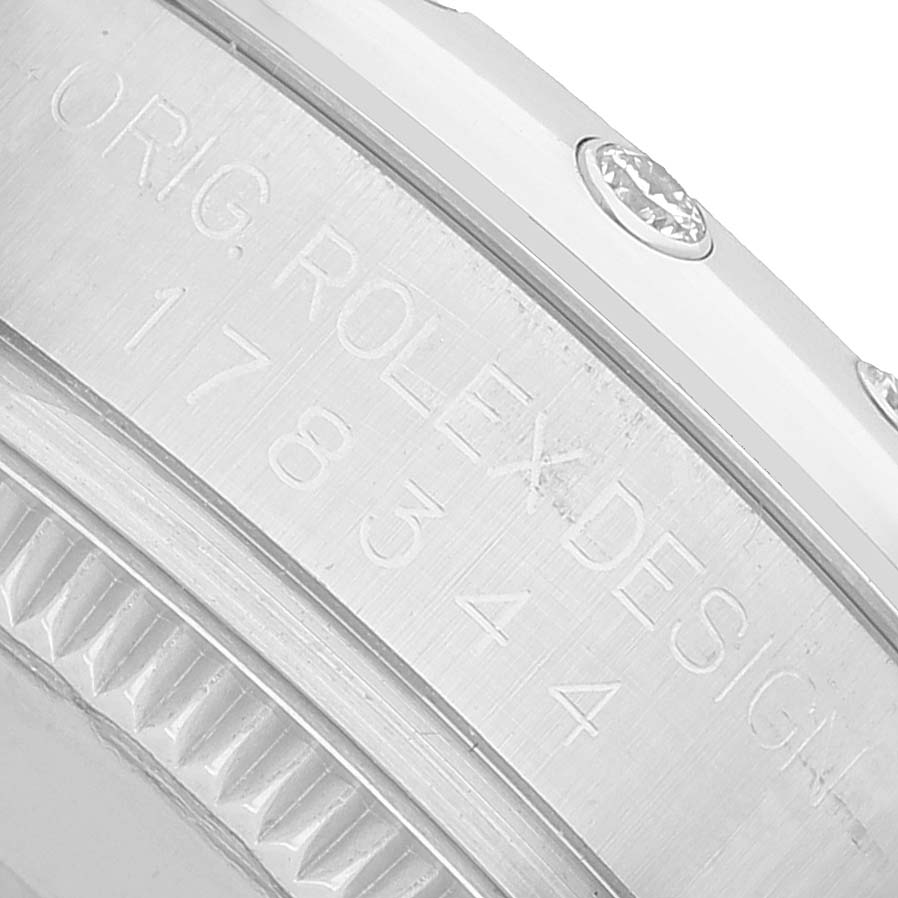 The image shows a close-up side view of a Rolex Mid-Size 178344 Women's Stainless Steel Mother of Pearl Dial model, featuring the engraved design and bezel details.