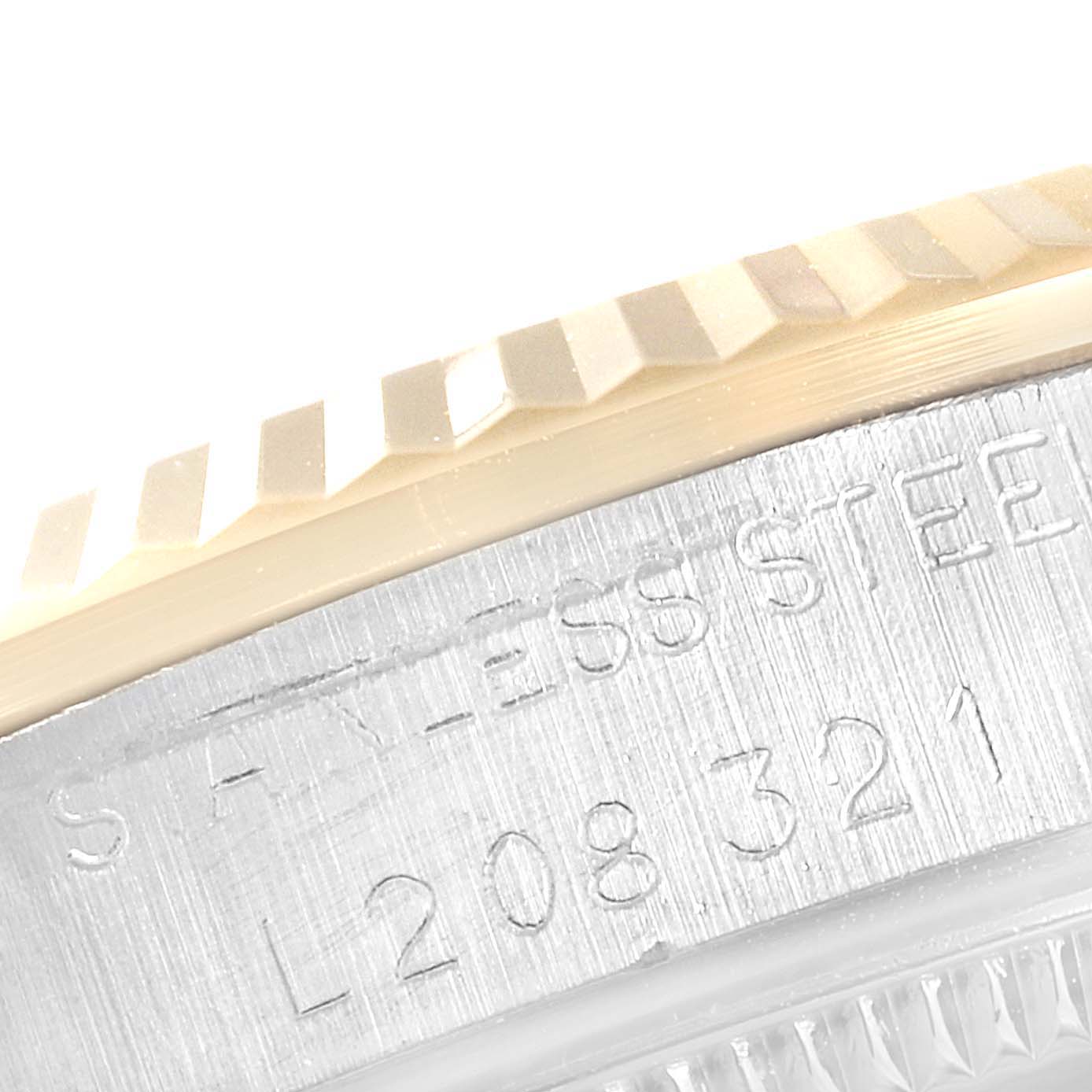 This close-up image shows the stainless steel engraving and the fluted bezel of a Rolex Datejust 68273 Women's Steel and Gold (two tone) Blue Dial 68273 Women's Steel and Gold (two tone) Blue Dial watch.