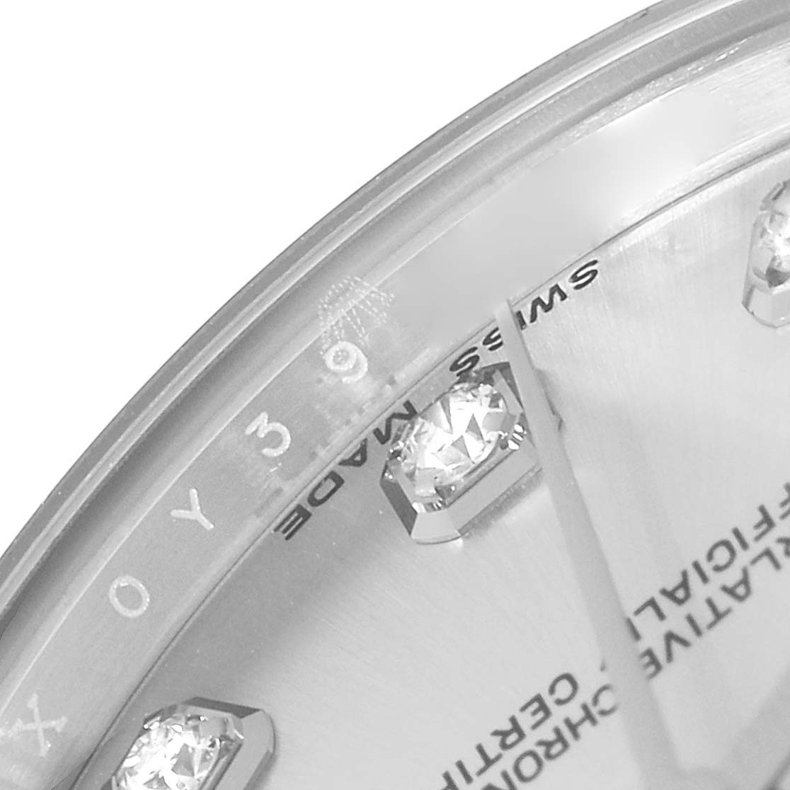 The image shows a close-up angle of the dial of a Mid-Size Rolex watch, highlighting the diamond markers and "Swiss Made" text.