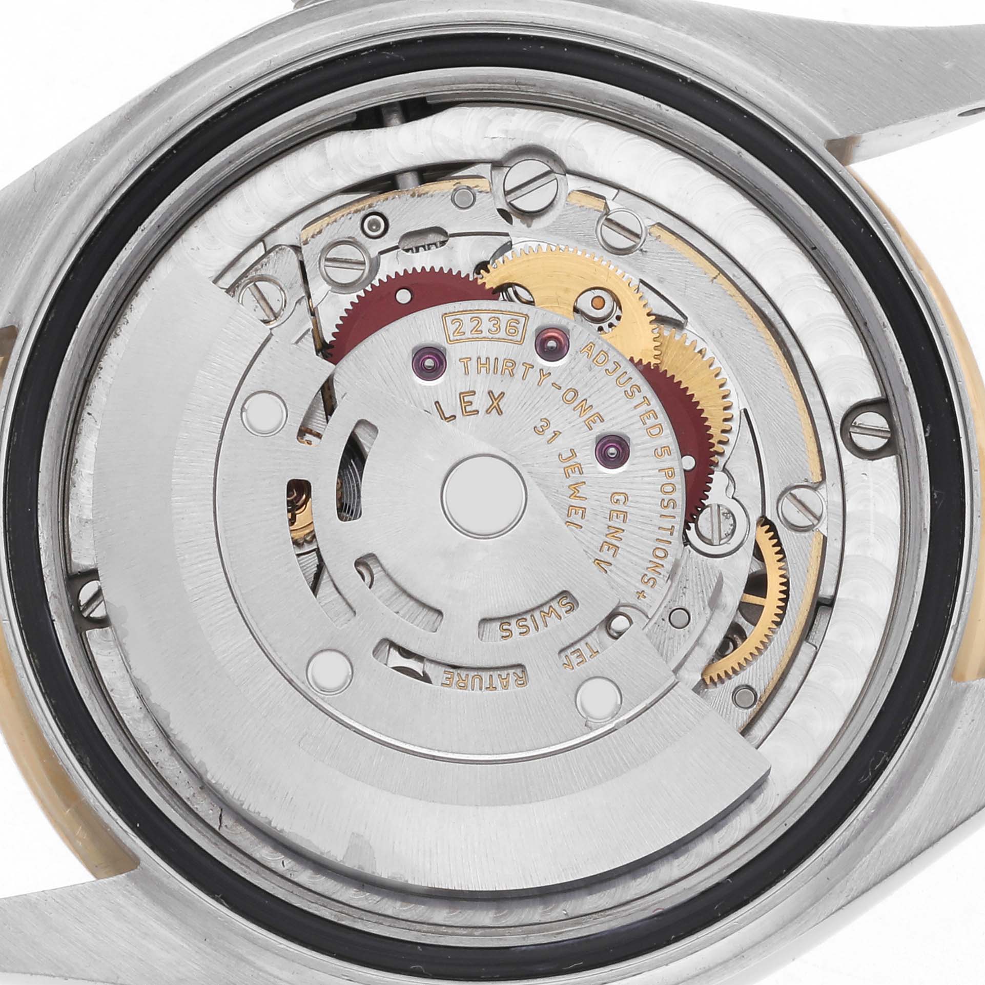 The image shows the internal mechanism of a Rolex Datejust 278243 Women's Steel and Gold (two tone) Silver Dial 278243 Women's Steel and Gold (two tone) Silver Dial, viewed from the back, highlighting gears, screws, and text details.