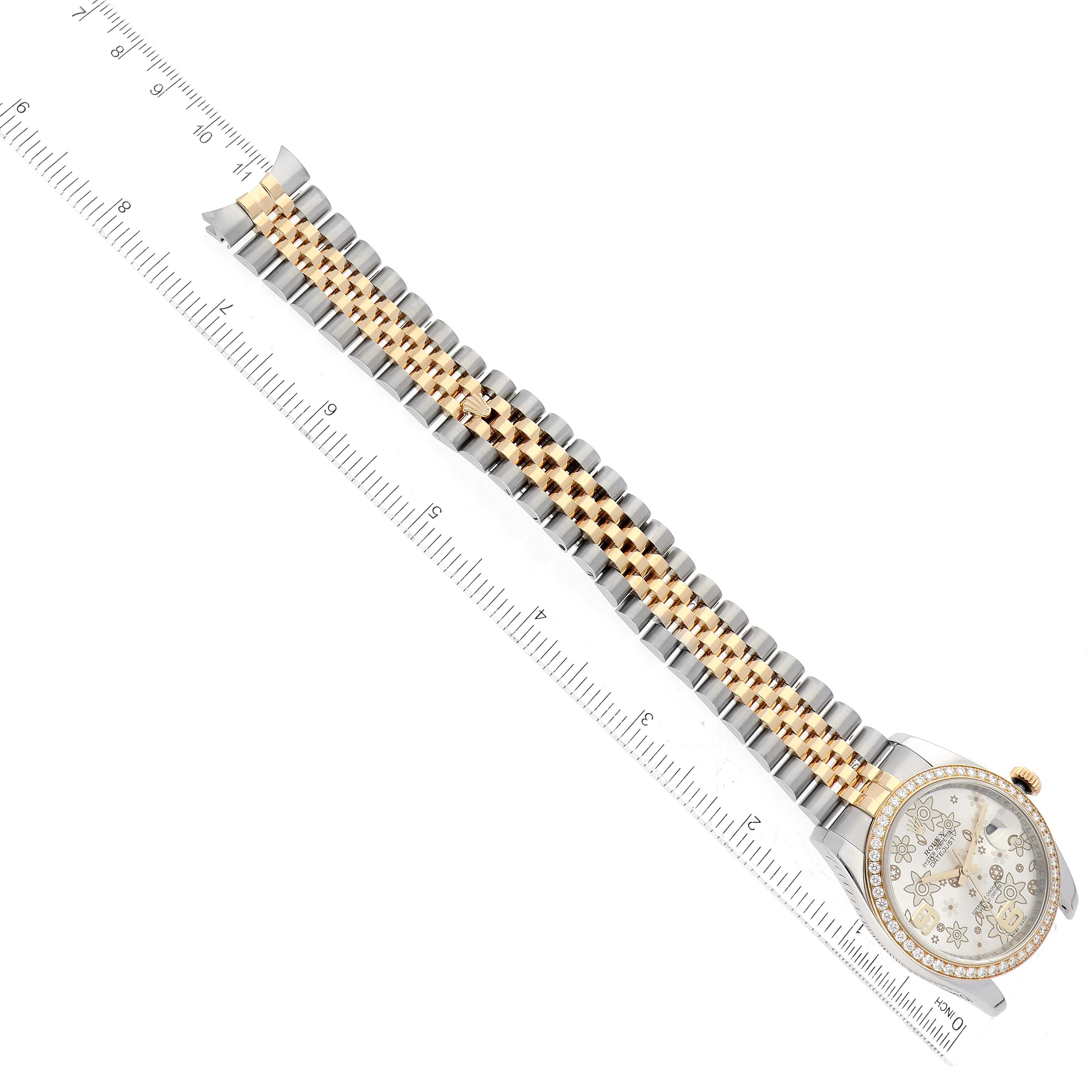 The Rolex Datejust 116243 Men's Steel and Gold (two tone) Silver Dial 116243 Men's Steel and Gold (two tone) Silver Dial watch is shown flat with a detailed view of the face and full bracelet alongside a ruler for scale.