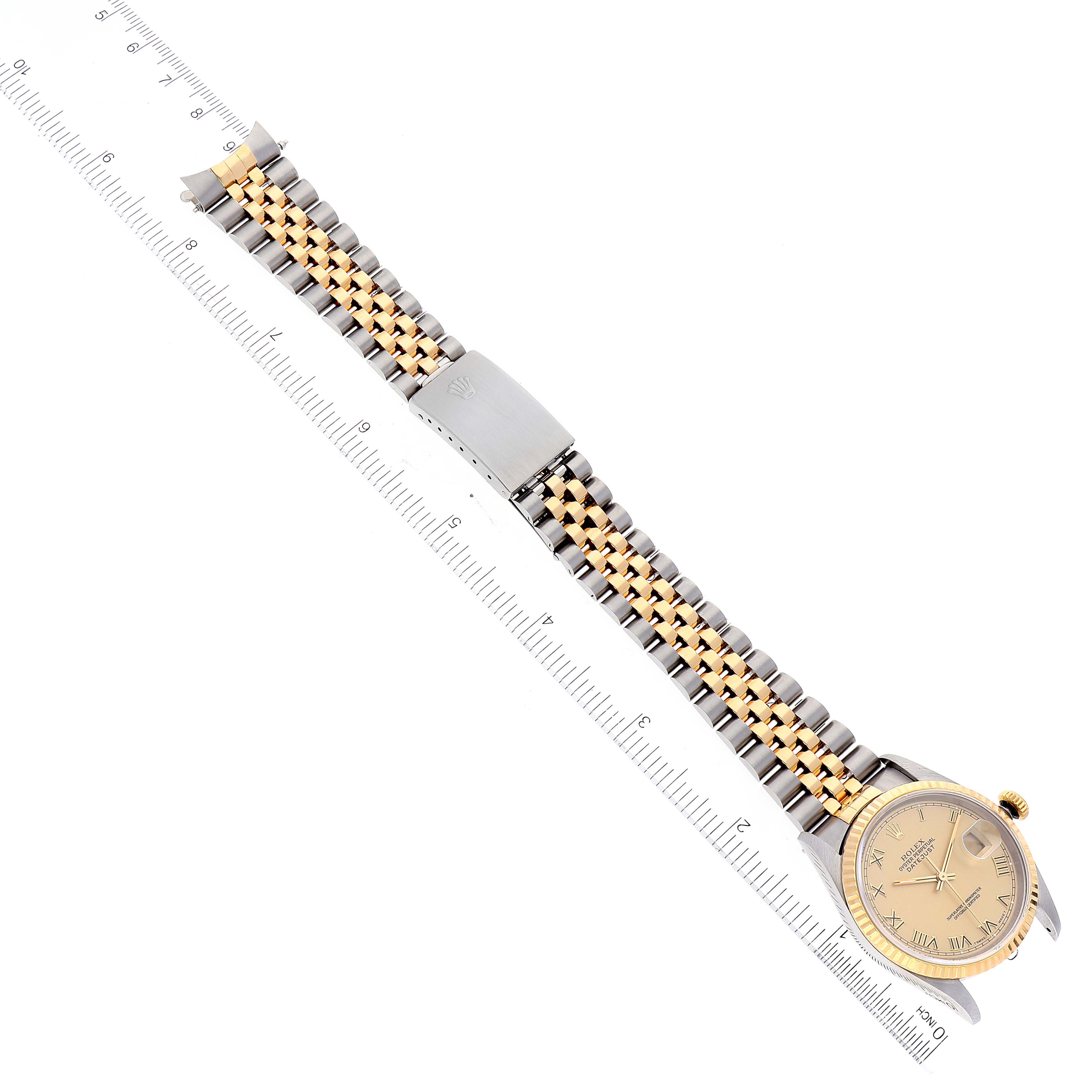 The image shows a top view of a Rolex Datejust 16233 Men's Steel and Gold (two tone) Champagne Dial 16233 Men's Steel and Gold (two tone) Champagne Dial watch, featuring the face, bezel, crown, and Jubilee bracelet alongside a ruler.