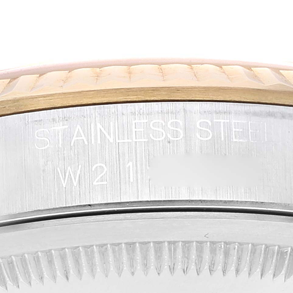 The image shows a close-up of the side view of the Rolex Datejust 16233 Men's Steel and Gold (two tone) Champagne Dial 16233 Men's Steel and Gold (two tone) Champagne Dial watch, highlighting the stainless steel bezel with engravings.