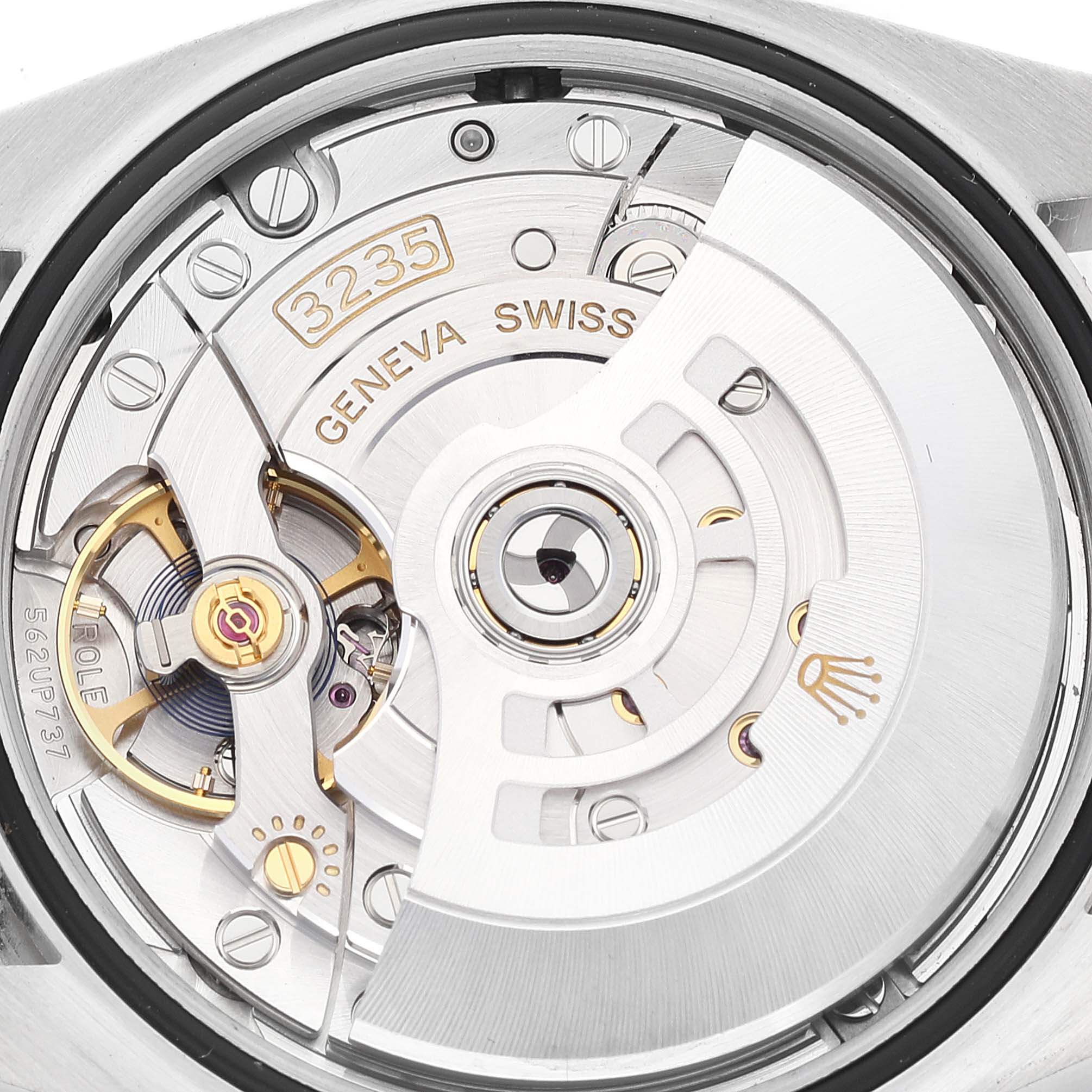 The image shows a close-up of the movement mechanism of a Rolex Datejust 126284RBR Men's Stainless Steel Black Dial 126284RBR Men's Stainless Steel Black Dial watch, detailing the rotor and intricate inner components.