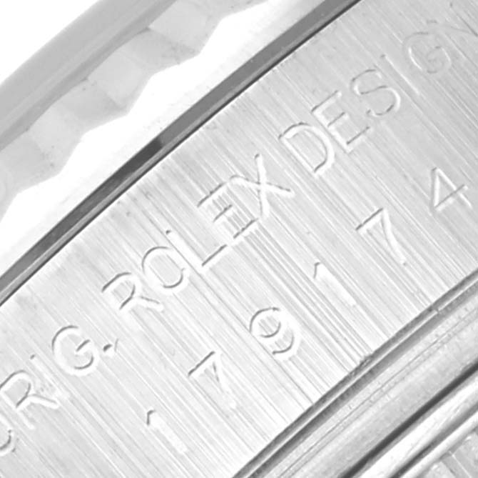 The image shows an angled close-up of the engravings on the case side of a Rolex Datejust 179174 Women
s Stainless Steel Black Dial 179174 Women
s Stainless Steel Black Dial watch.