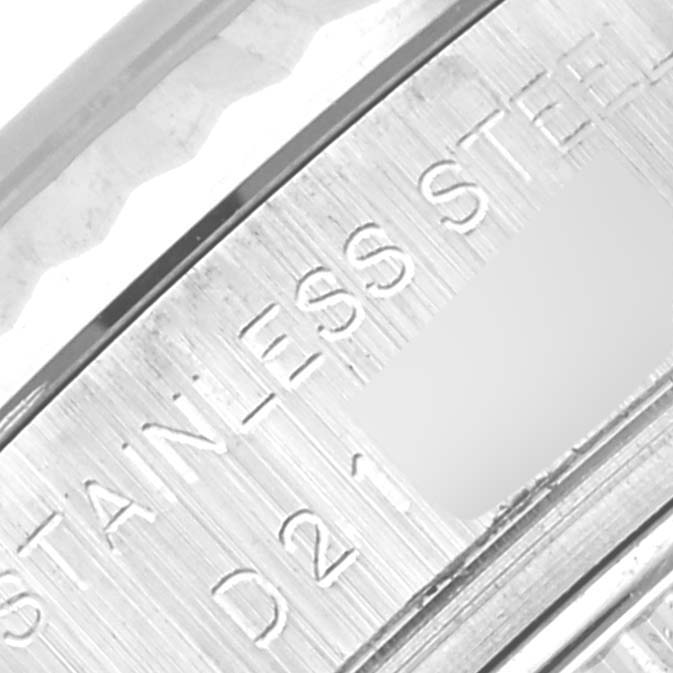 The image shows a close-up of the stainless steel casing edge of a Rolex Datejust 179174 Women
s Stainless Steel Black Dial 179174 Women
s Stainless Steel Black Dial watch with engraved text.