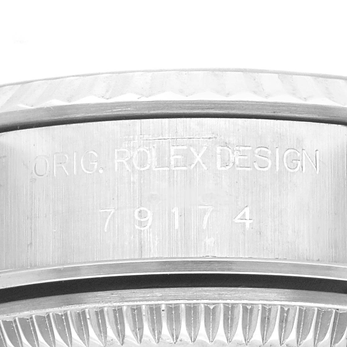 The image shows a close-up view of the serial number engraving on the case of a Rolex Datejust 79174 Women's Stainless Steel Black Dial 79174 Women's Stainless Steel Black Dial watch.