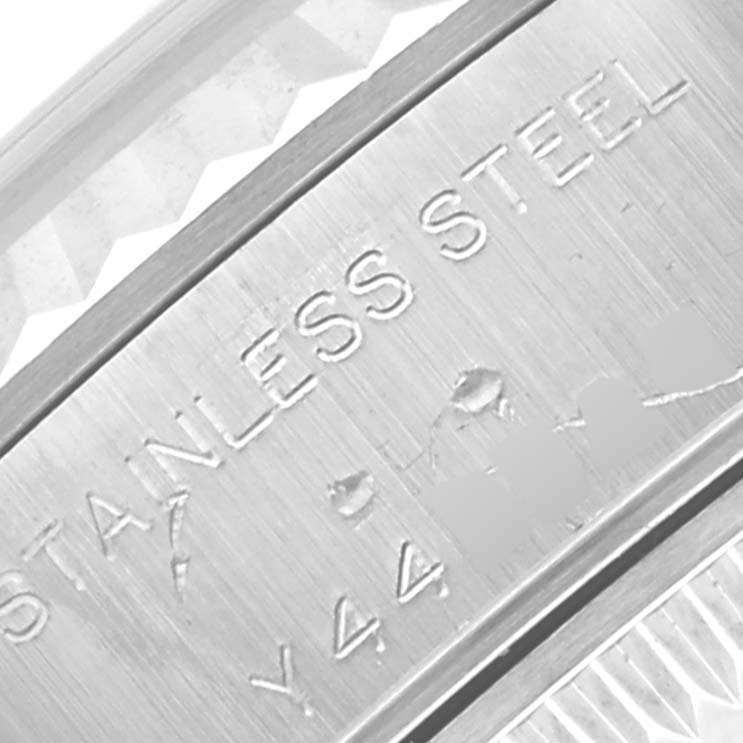 This close-up shot of the Rolex Datejust 79174 Women
s Stainless Steel Silver Dial 79174 Women
s Stainless Steel Silver Dial watch shows the engraved text indicating "STAINLESS STEEL" and part of the model and serial number.