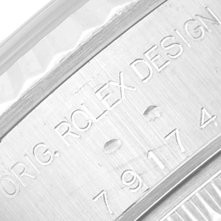 This close-up image shows the engraved serial number and design details on the case side of a Rolex Datejust 79147 Women's Stainless Steel Mother of Pearl Dial 79147 Women's Stainless Steel Mother of Pearl Dial watch.