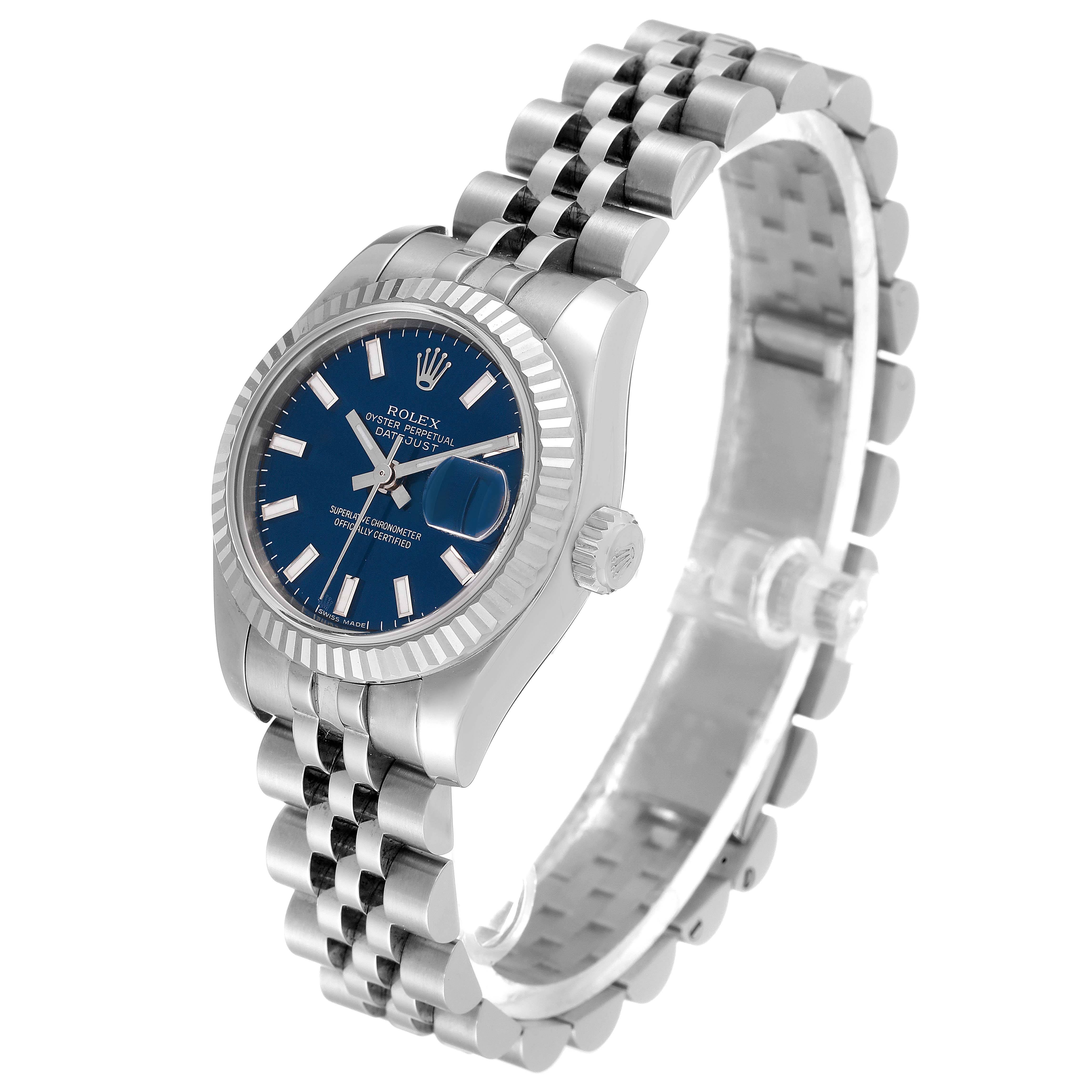 The Rolex Datejust 179174 Women
s Stainless Steel Blue Dial 179174 Women
s Stainless Steel Blue Dial watch is shown at an angle displaying its blue dial, jubilee bracelet, fluted bezel, and cyclops date window.