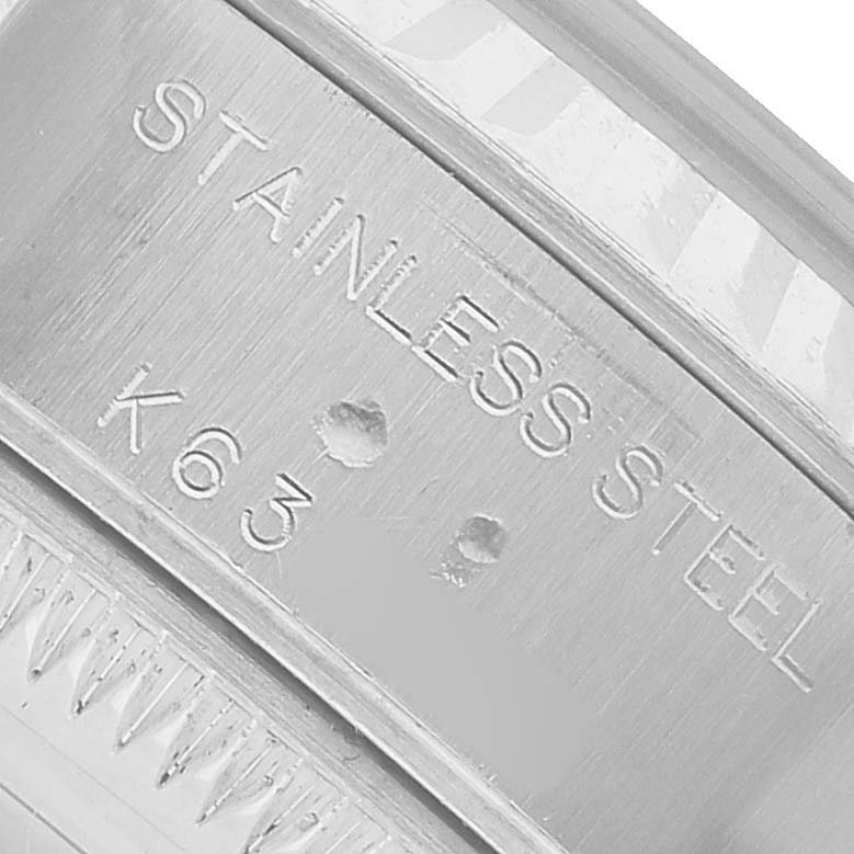 The image shows a close-up of the Rolex Datejust 79174 Women's Stainless Steel Silver Dial watch's stainless steel bracelet with engraving details.