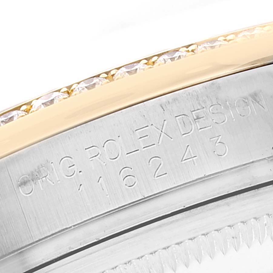 This is a close-up angle of the bezel and case number of the Rolex Datejust 116243 Men's Steel and Gold (two tone) Silver Dial 116243 Men's Steel and Gold (two tone) Silver Dial watch, showing "ROLEX DESIGN" and model number 16243.
