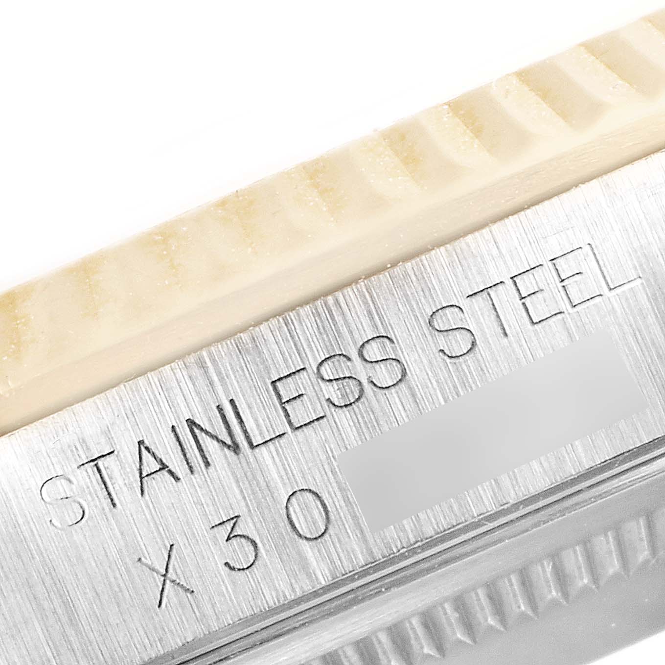 This close-up shows the stainless steel part of the bezel and case of the Rolex Datejust 16233 Men's Steel and Gold (two tone) Champagne Dial 16233 Men's Steel and Gold (two tone) Champagne Dial model.