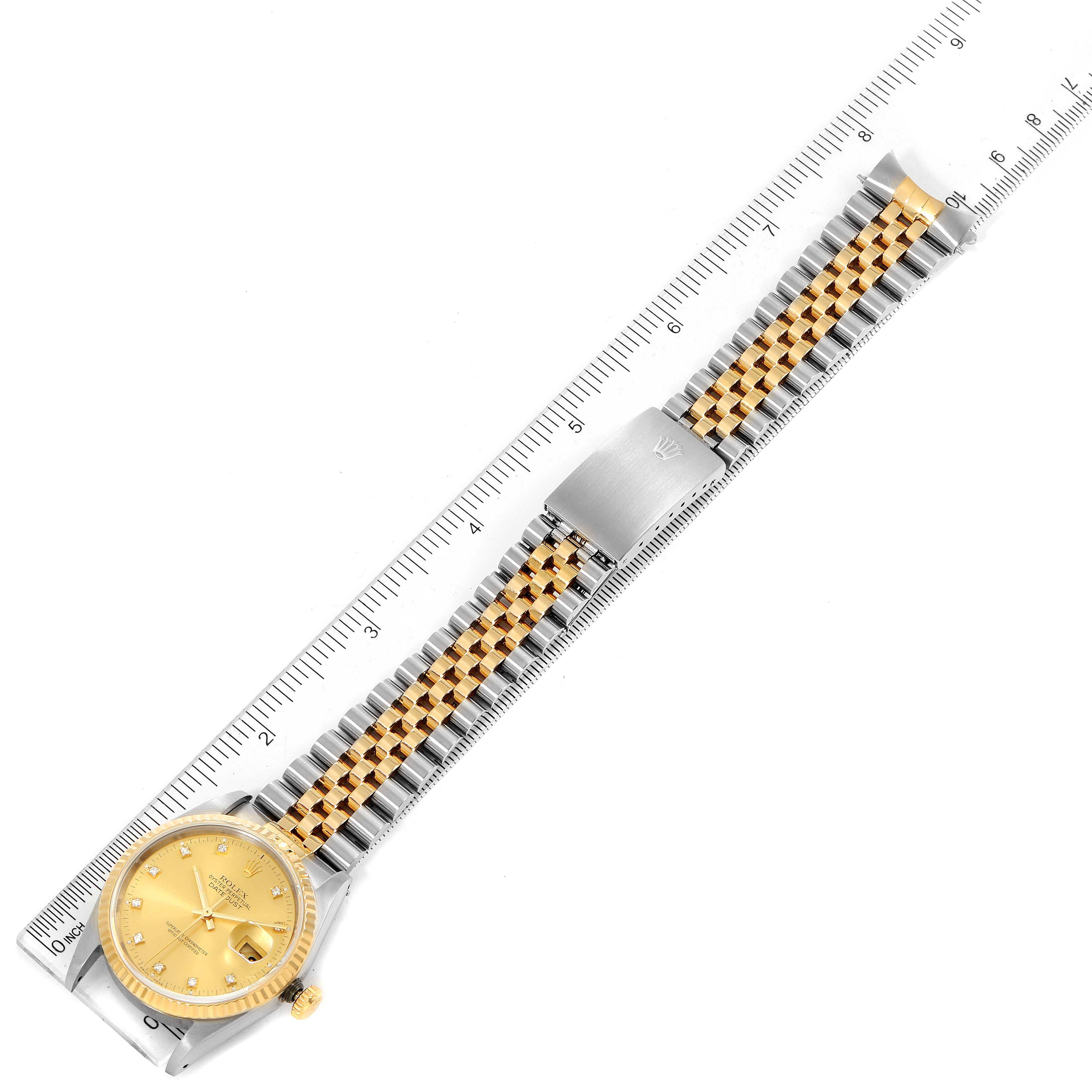 The image shows a Rolex Datejust 16233 Men's Steel and Gold (two tone) Champagne Dial 16233 Men's Steel and Gold (two tone) Champagne Dial watch laid flat with its entire band extended alongside a ruler for measurement.