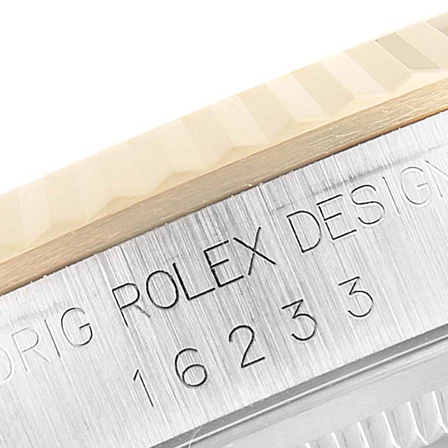 This image shows a close-up of the engraved bezel and case edge of a Rolex Datejust 16233 Men's Steel and Gold (two tone) Champagne Dial 16233 Men's Steel and Gold (two tone) Champagne Dial watch.