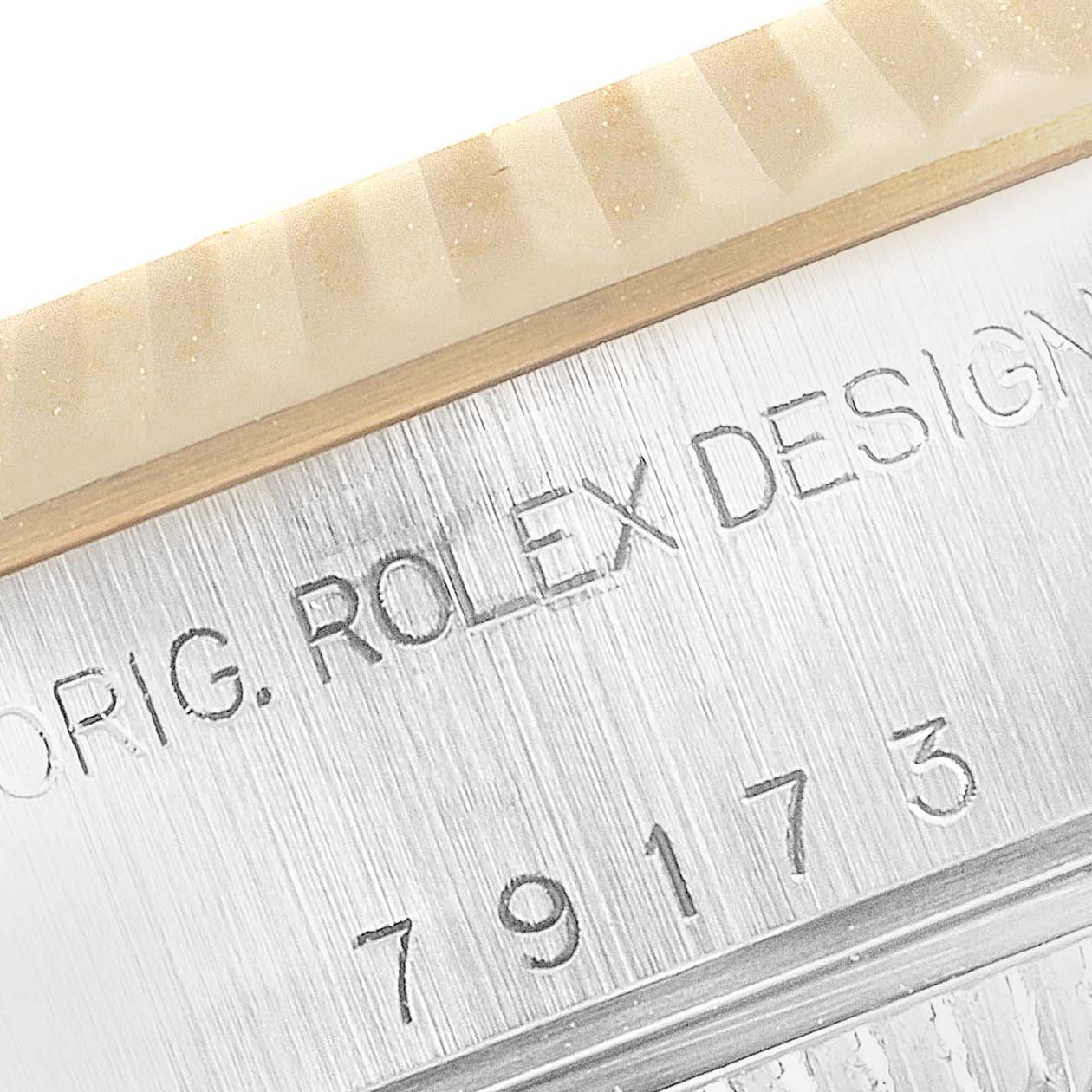 The image shows a close-up view of the Rolex Datejust 79173 Women's Steel and Gold (two tone) Silver Dial 79173 Women's Steel and Gold (two tone) Silver Dial watch's engraved model number "79173" and part of the bezel.