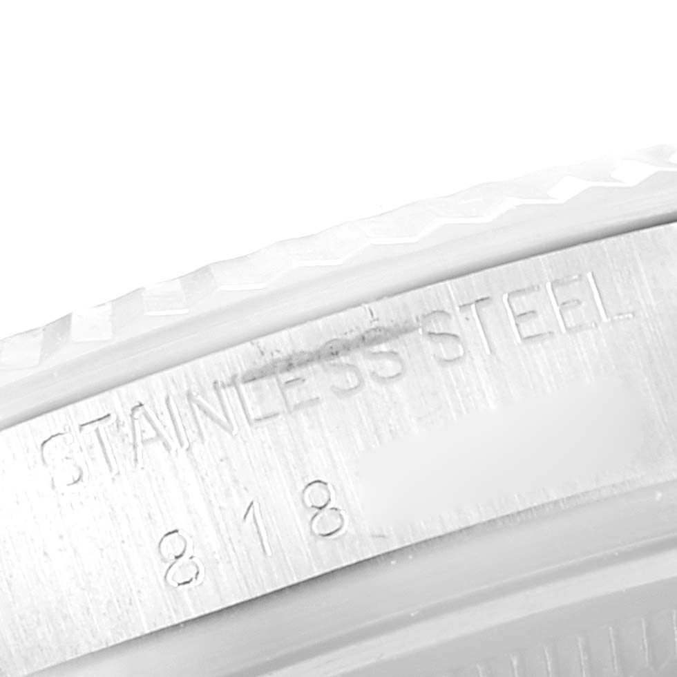The image shows a close-up of the side of a stainless steel Vintage Collection watch by Rolex, featuring engraved text and numbers.