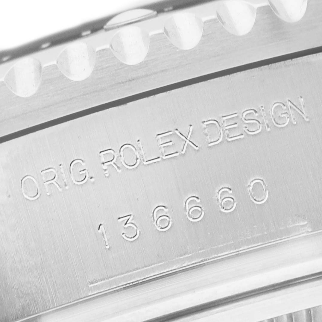 The image shows a close-up angle of the case side engraving on a Rolex Sea-Dweller 136660 Men's Stainless Steel Blue Dial, displaying the model and design numbers.