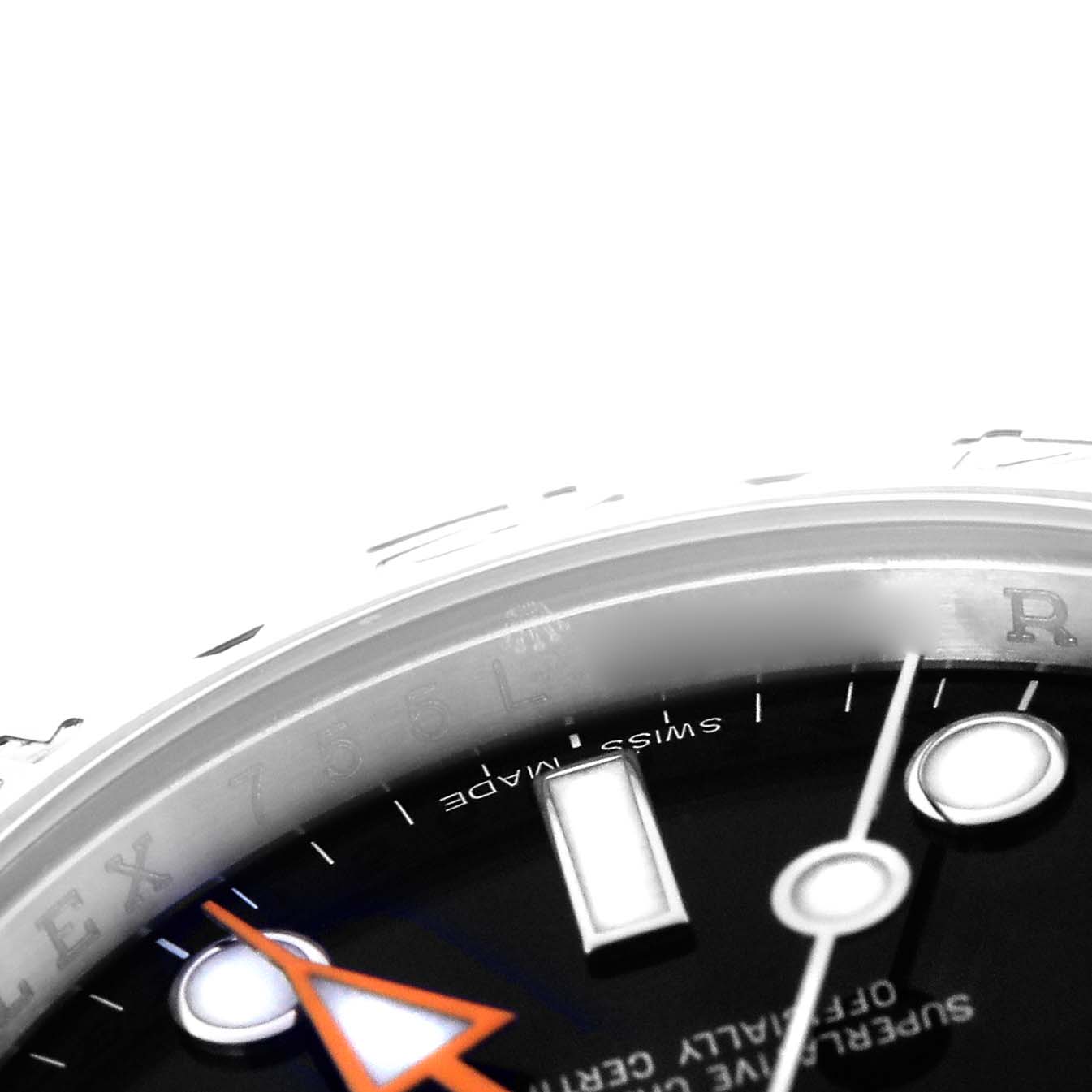 The image shows a close-up of the dial and bezel edge of a Rolex Explorer 216570 Men
s Stainless Steel Black Dial 216570 Men
s Stainless Steel Black Dial, highlighting the orange hand and part of the indices.