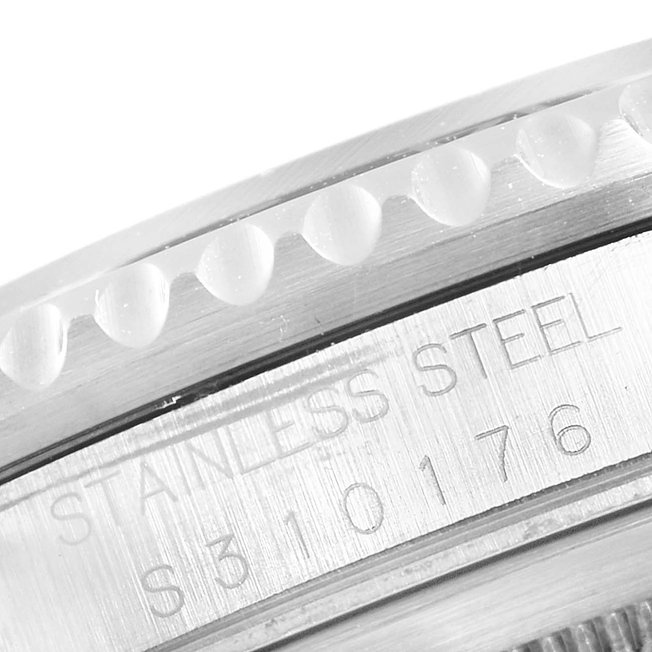 Close-up of the stainless steel case, bezel, and engraved serial number of a Rolex GMT-Master 16700 Men's Stainless Steel Black Dial 16700 Men's Stainless Steel Black Dial watch.