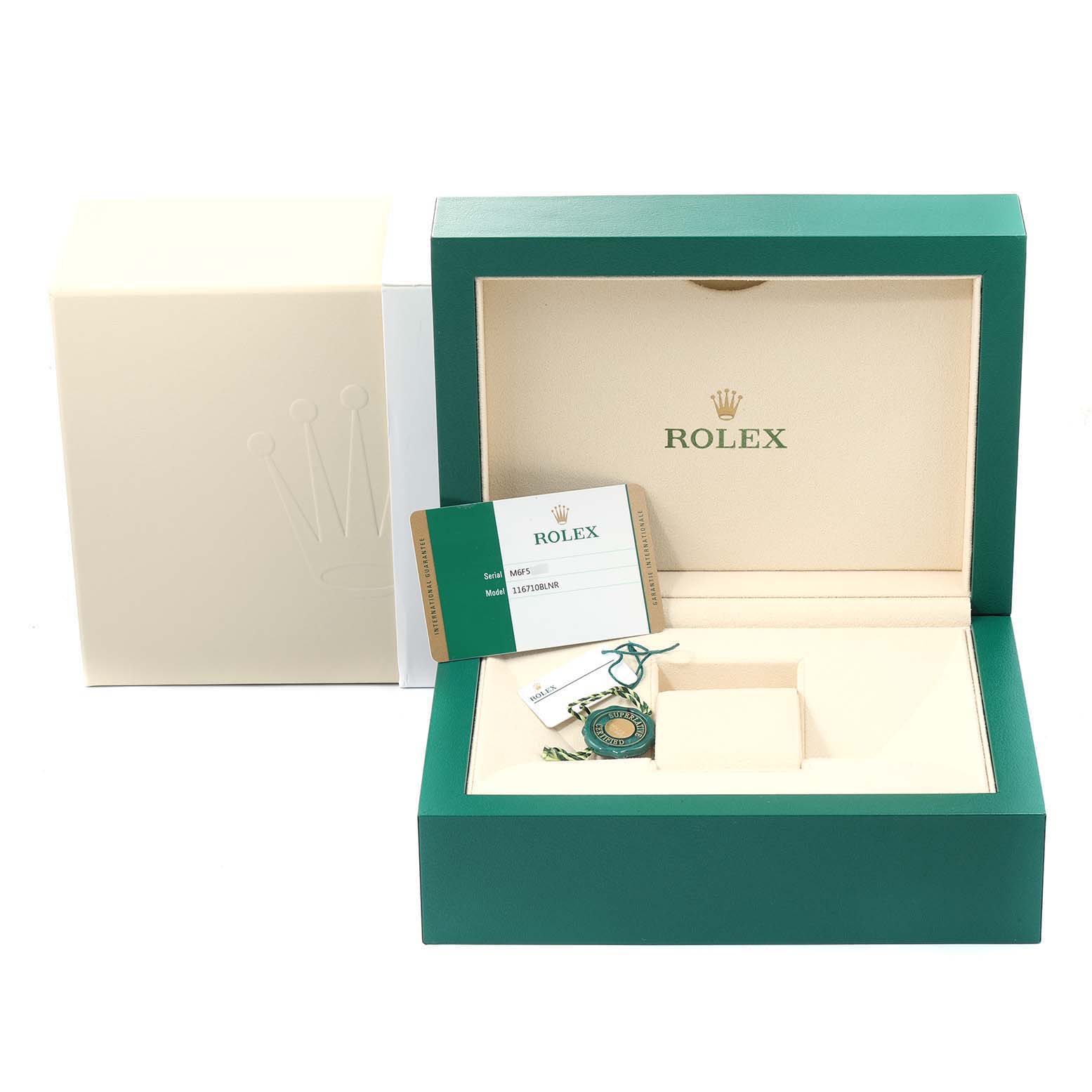 The image shows an open green and beige Rolex watch box for a GMT-Master model, along with the warranty card and a tag.