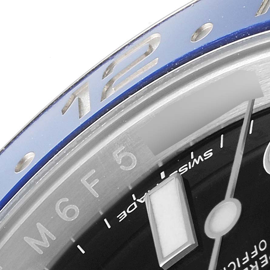 This close-up image of the Rolex GMT-Master 116710 Men's Stainless Steel Black Dial 116710 Men's Stainless Steel Black Dial watch shows part of the bezel and dial.