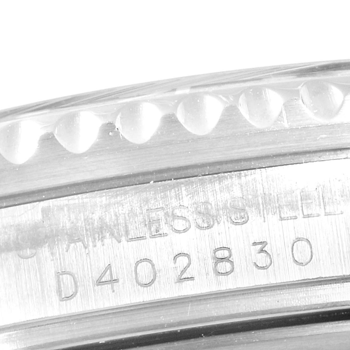 This close-up image of the Rolex GMT-Master 16710 Men's Stainless Steel Black Dial 16710 Men's Stainless Steel Black Dial watch focuses on the engraved serial number and part of the caseback's edge.