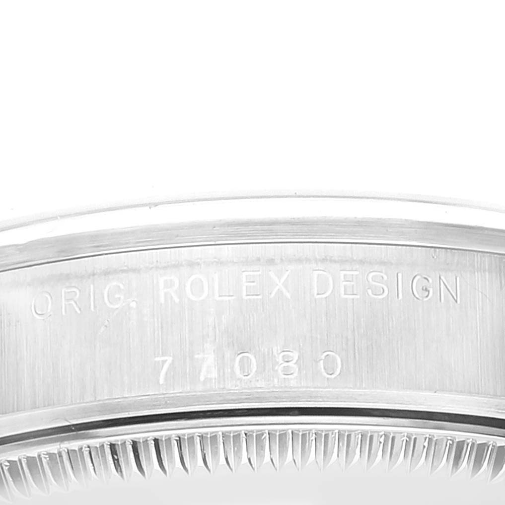 This image shows a close-up of the case side, featuring the engraved model number of a Rolex Mid-Size 77080 Women
s Stainless Steel Pink Dial 77080 Women
s Stainless Steel Pink Dial watch.