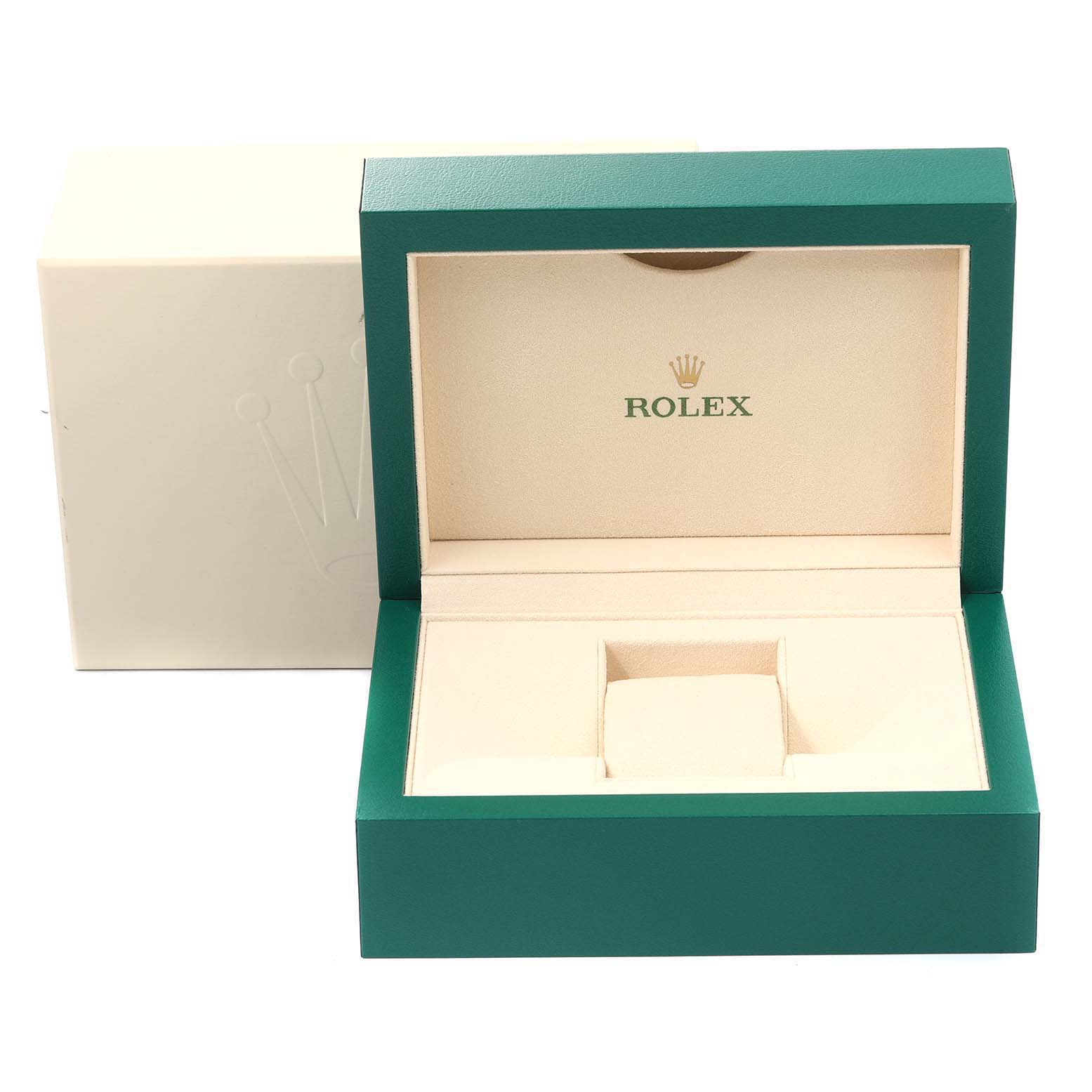 The image shows an open Rolex watch box for the Oyster Perpetual model, featuring a green exterior and beige interior.