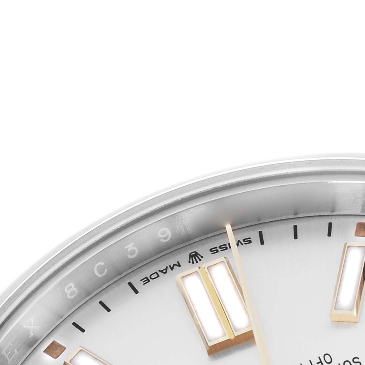 The image shows a close-up of the dial
s edge of a Rolex Oyster Perpetual 124300 Men
s Stainless Steel Silver Dial 124300 Men
s Stainless Steel Silver Dial, featuring index markers and part of the "Swiss Made" text.