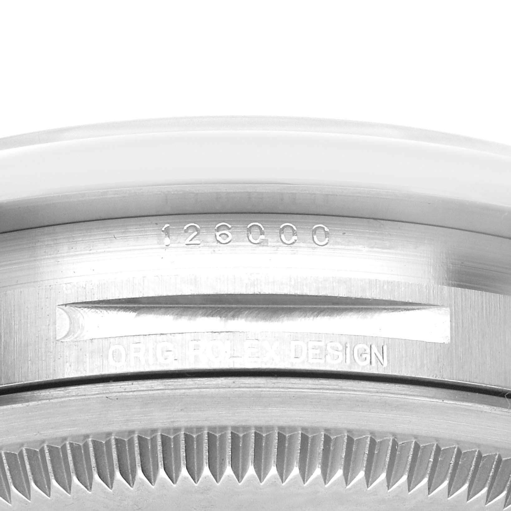 The image shows a close-up of the side of a Rolex Oyster Perpetual 126000 Men's Stainless Steel Red Dial 126000 Men's Stainless Steel Red Dial watch, revealing the model number 126000 and "ORIG ROLEX DESIGN."