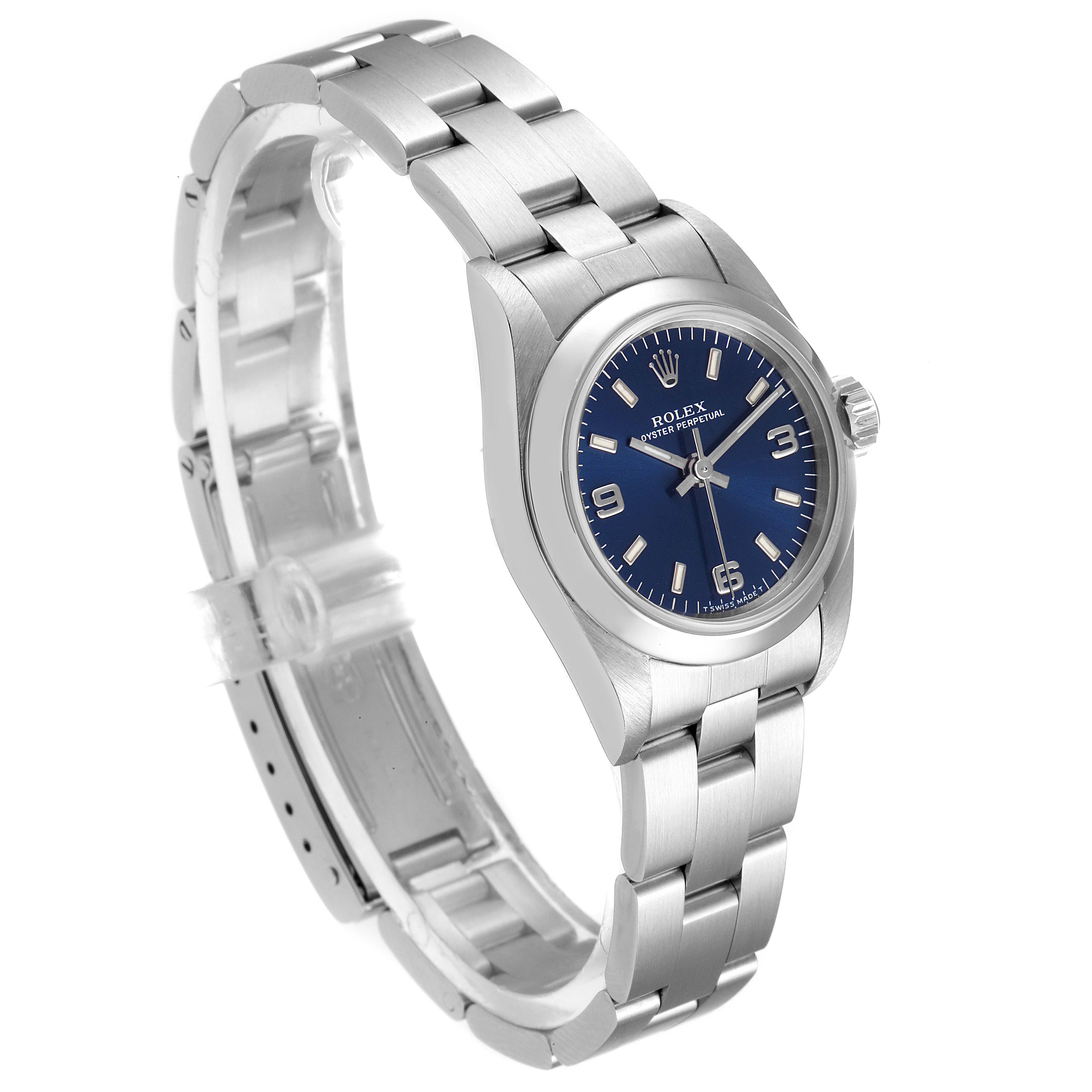 The Rolex Oyster Perpetual 67180 Women's Stainless Steel Blue Dial 67180 Women's Stainless Steel Blue Dial watch is shown at a three-quarter angle, displaying the blue dial, crown, and stainless steel bracelet.