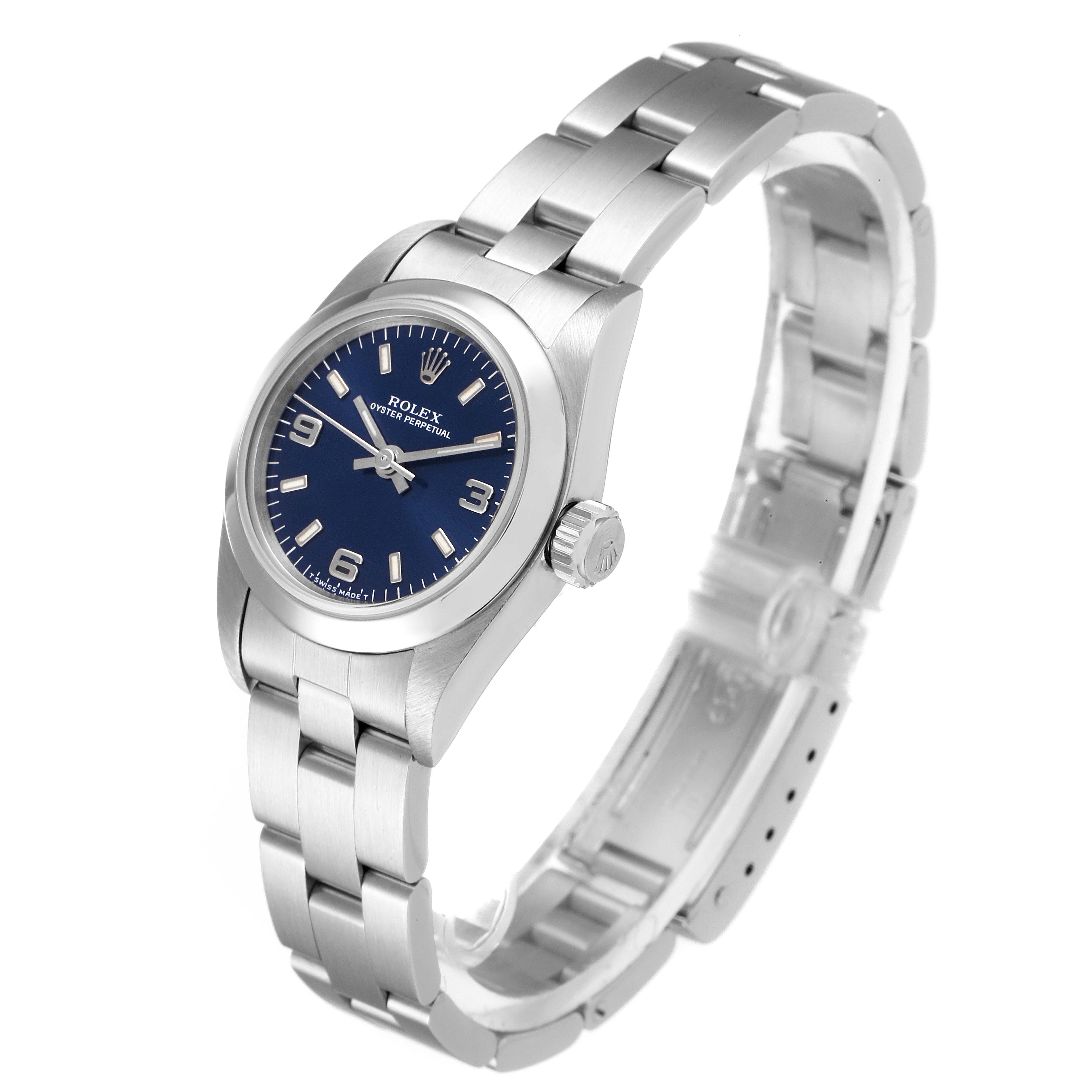 This image shows a Rolex Oyster Perpetual 67180 Women's Stainless Steel Blue Dial 67180 Women's Stainless Steel Blue Dial watch from an oblique angle, highlighting the dial, bezel, crown, and bracelet.