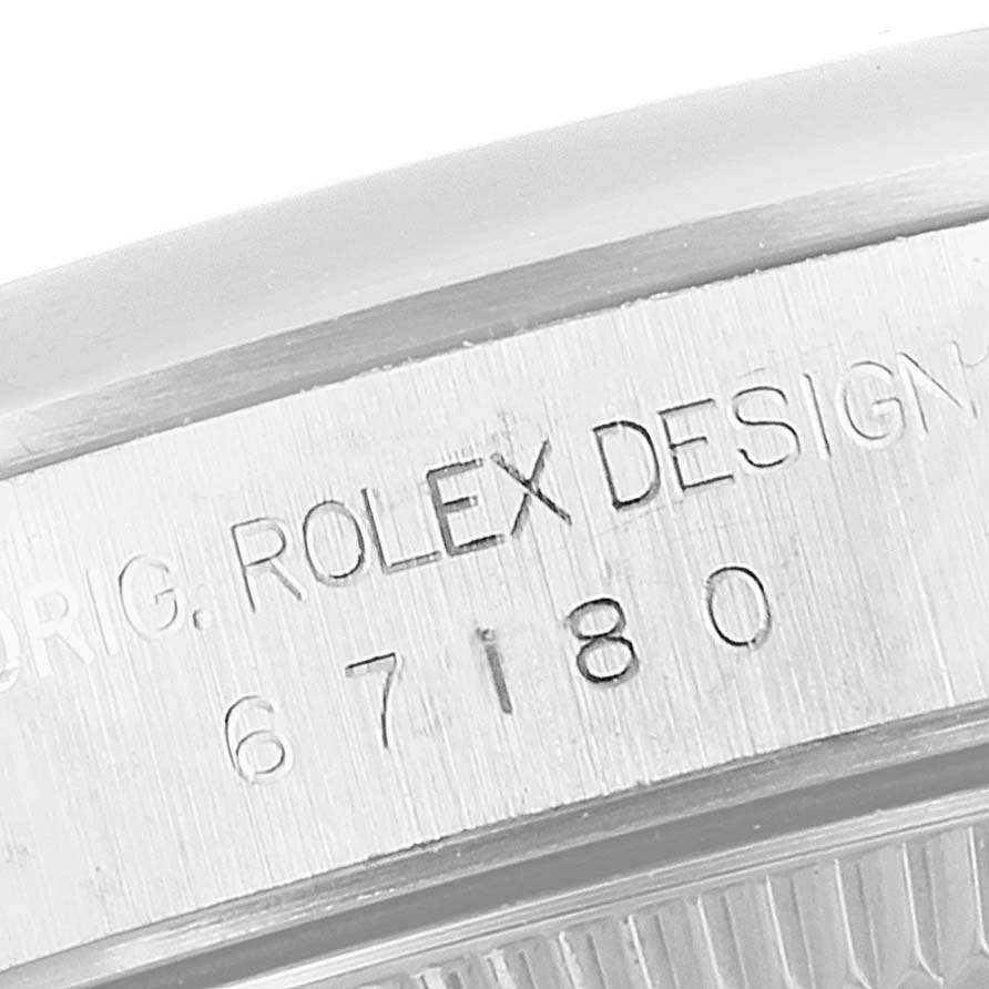 This is a close-up angle of the serial number and "Rolex Design" engraving on the side of a Rolex Oyster Perpetual 67180 Women's Stainless Steel Blue Dial 67180 Women's Stainless Steel Blue Dial watch.