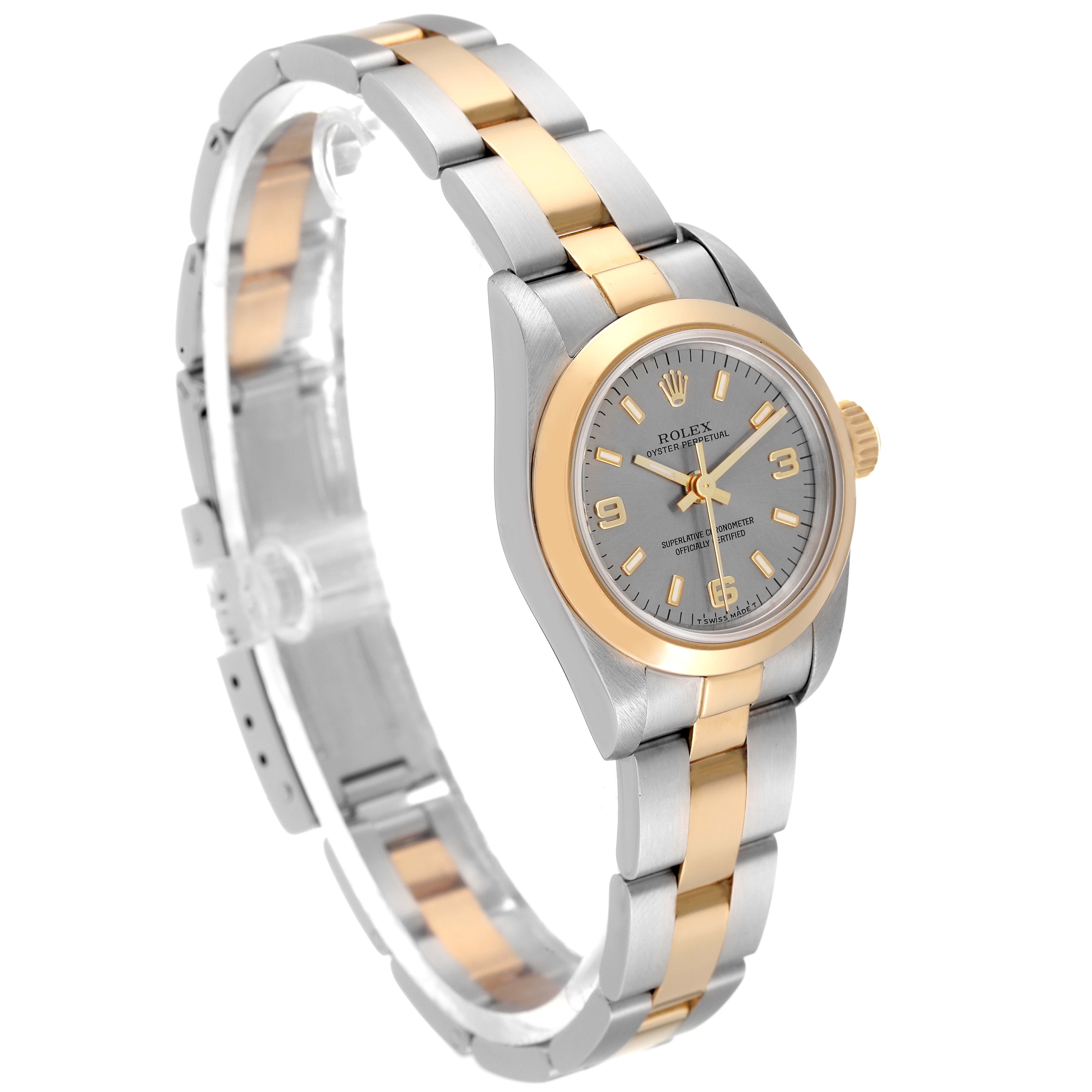The Rolex Oyster Perpetual 67183 Women's Steel and Gold (two tone) Grey Dial 67183 Women's Steel and Gold (two tone) Grey Dial watch is shown at a side angle featuring its two-tone metal bracelet and silver dial.
