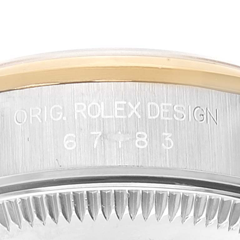 The image shows a close-up of the side of the bezel and caseback of a Rolex Oyster Perpetual 67183 Women's Steel and Gold (two tone) Grey Dial 67183 Women's Steel and Gold (two tone) Grey Dial watch, highlighting the design engraving and model number.
