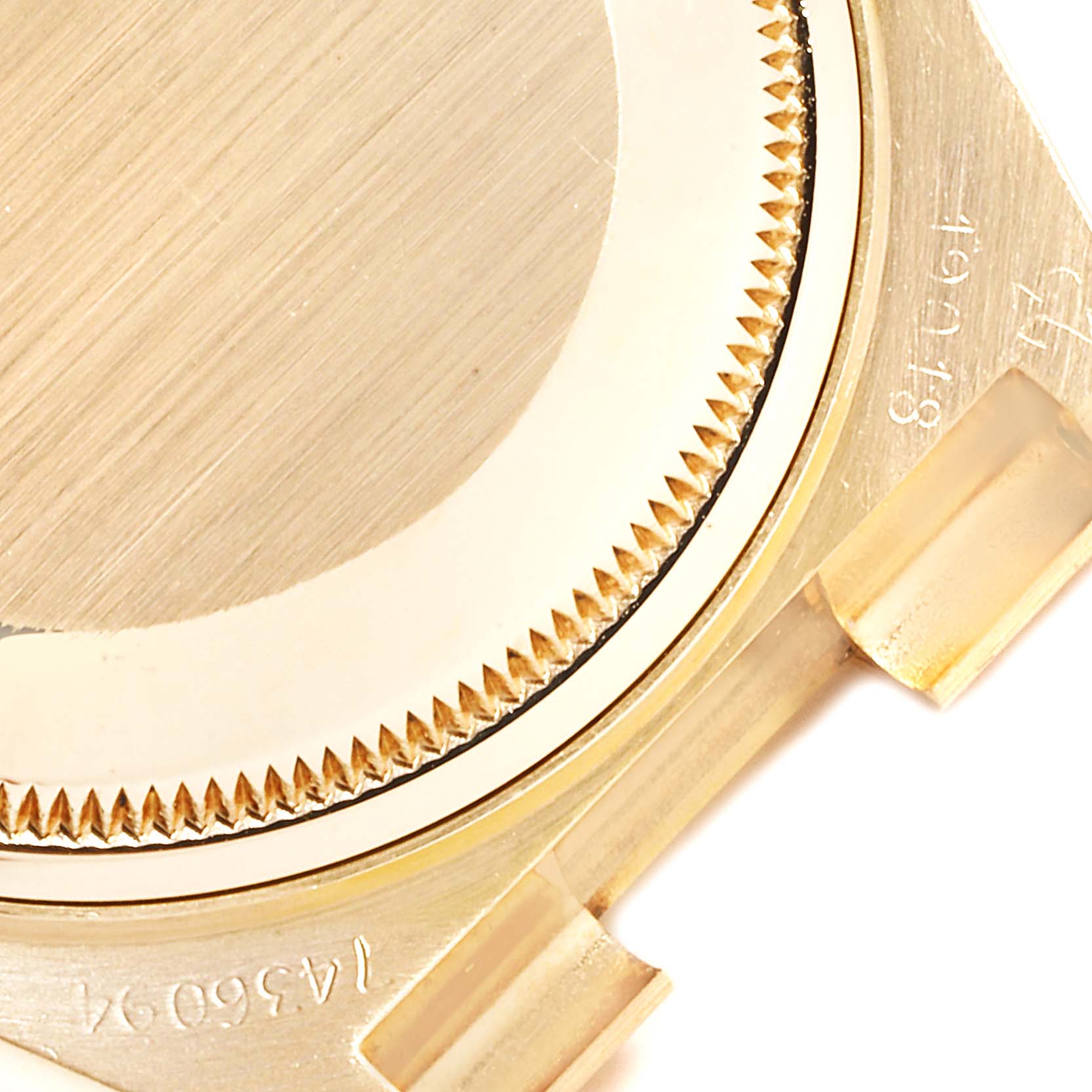 The image shows the back case and part of the lugs of a Rolex Oysterquartz 19018 Men
s Yellow Gold Champagne Dial 19018 Men
s Yellow Gold Champagne Dial watch, captured from a close-up top angle.