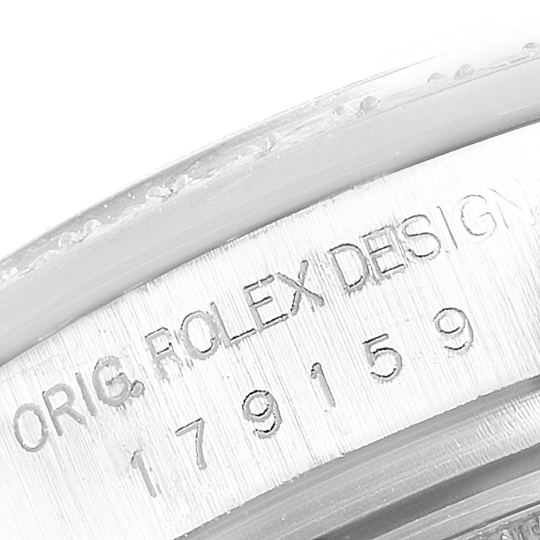 The image shows a close-up of the engravings on the side of a Rolex President 179159 Women's White Gold Silver Dial 179159 Women's White Gold Silver Dial model watch.