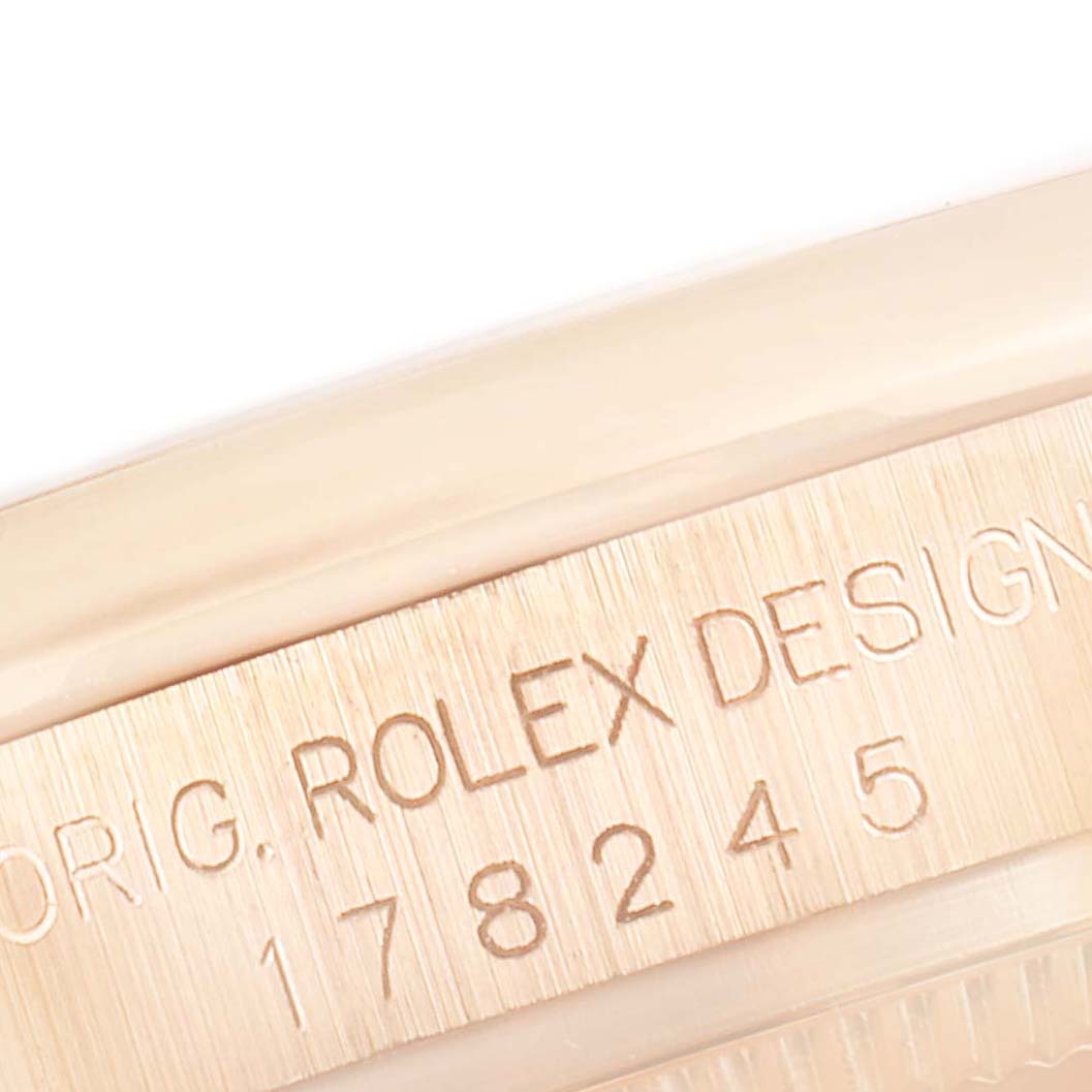 The image shows a close-up of the Rolex President 178245 Women's Rose Gold Silver Dial 178245 Women's Rose Gold Silver Dial model's case, featuring the engraved serial number and "ROLEX DESIGN."