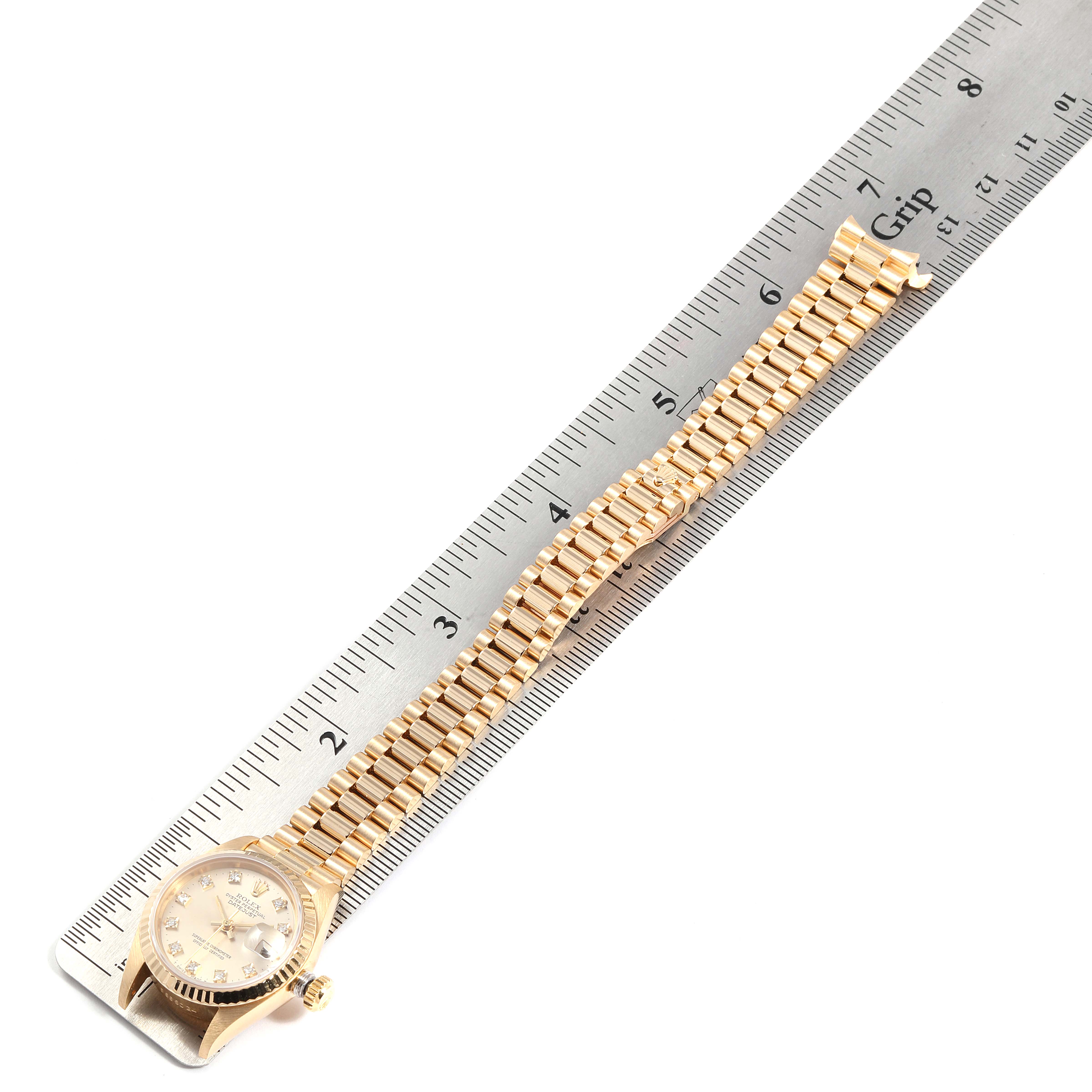 The image shows a Rolex President 69178 Women's Yellow Gold Silver Dial 69178 Women's Yellow Gold Silver Dial model watch and its band, laid flat beside a ruler for measurement.
