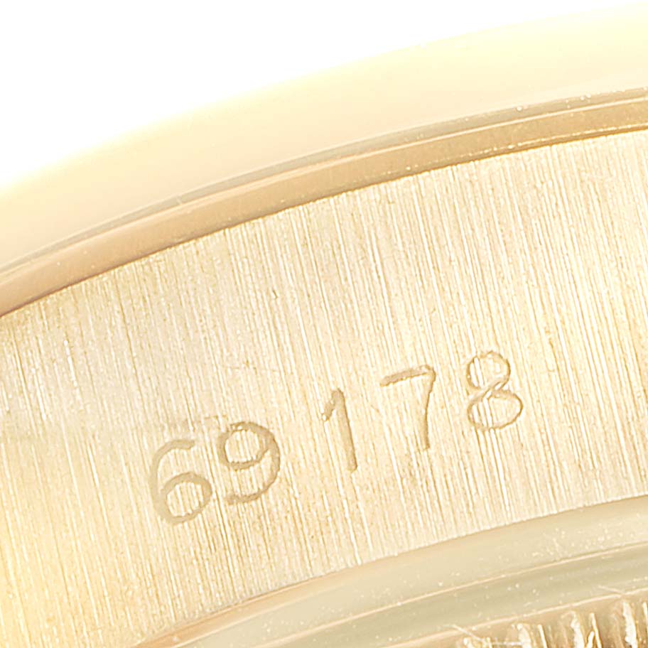 This close-up image shows the engraved reference number on the case of a Rolex President 69178 Women's Yellow Gold Silver Dial 69178 Women's Yellow Gold Silver Dial model watch.