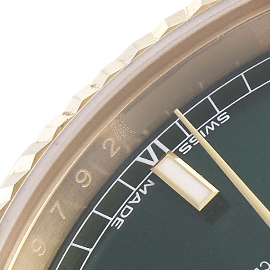 This close-up image shows a partial view of the dial, bezel, and hour markers of a Rolex President 118138 Men's Yellow Gold Green Dial 118138 Men's Yellow Gold Green Dial watch.